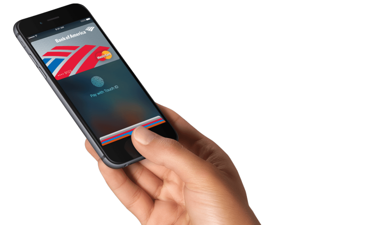 Apple Pay hand holding iPhone
